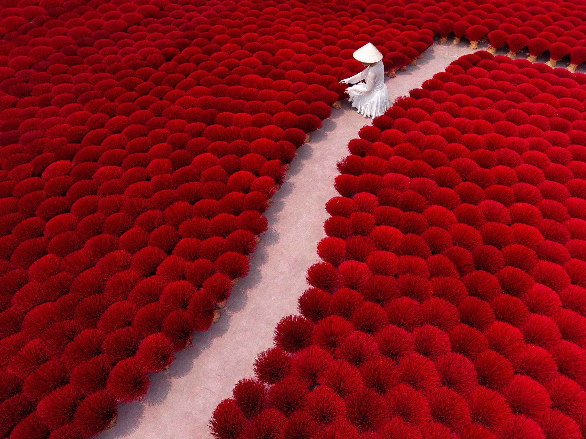 female-worker-amidst-vibrant-red-incense