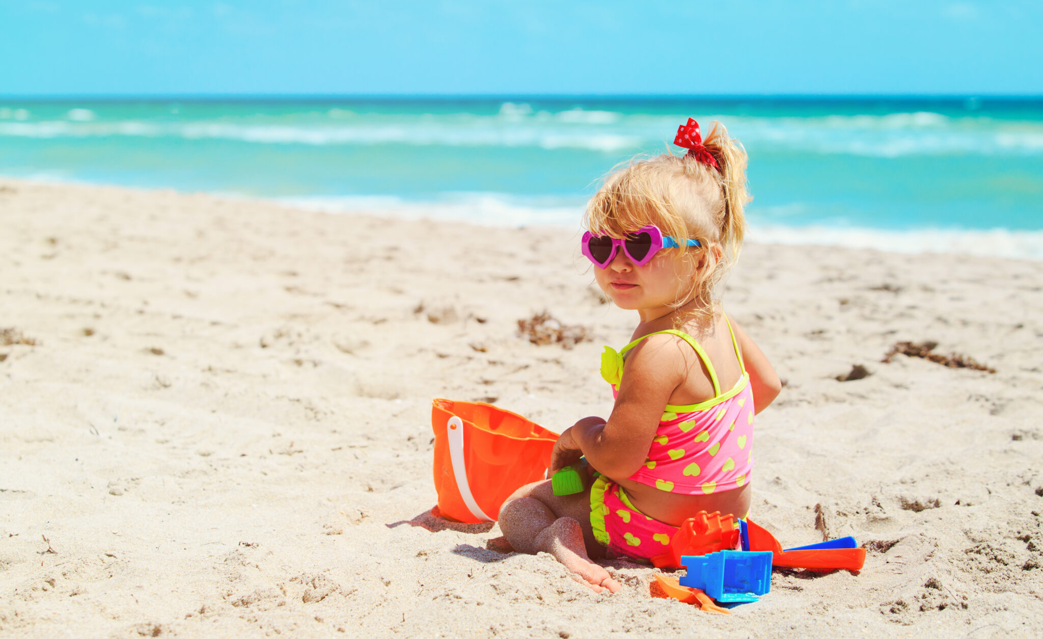 Cute,Little,Girl,Play,With,Sand,On,Beach